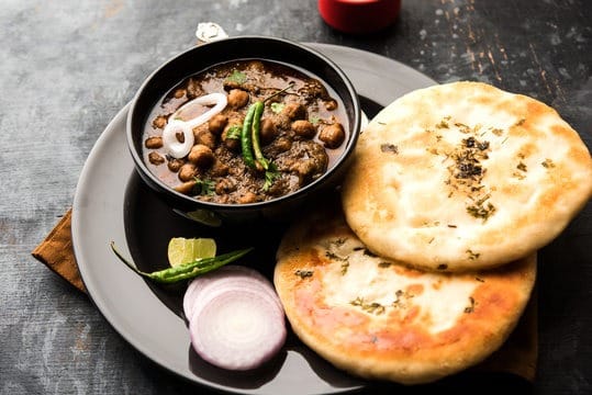 bowl of spicy chhole and kulche