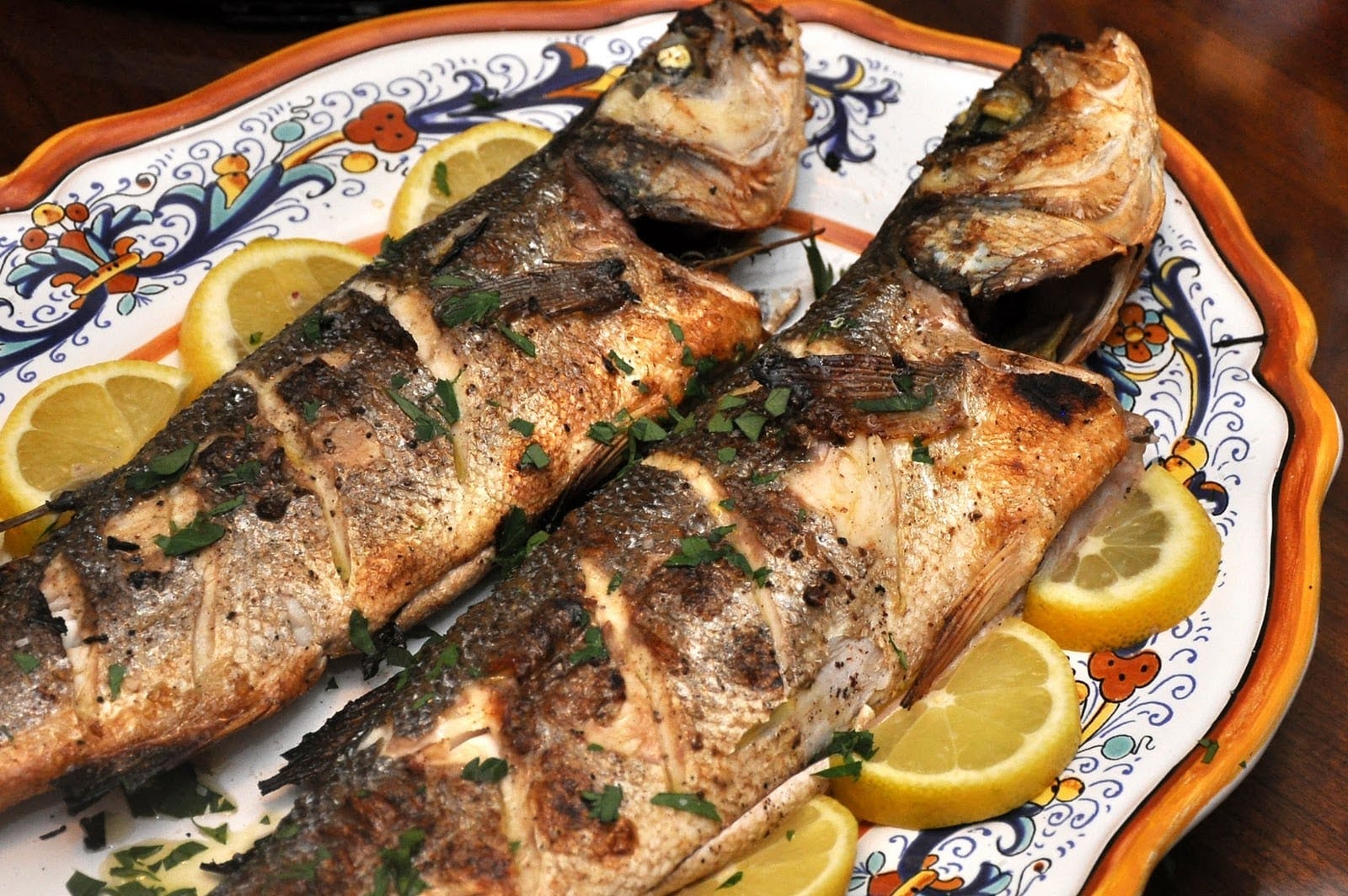 a plate of fish and lemonade on a table